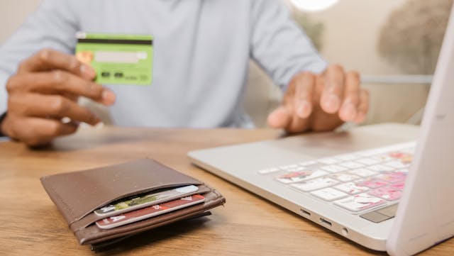 Person%20holding%20a%20credit%20card%20to%20make%20an%20online%20payment Person%20holding%20a%20credit%20card%20to%20make%20an%20online%20payment